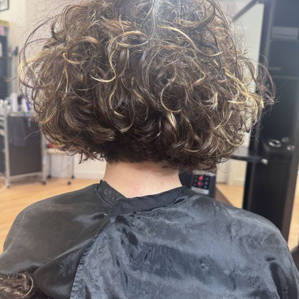 Curly brunette with hand-painted highlights